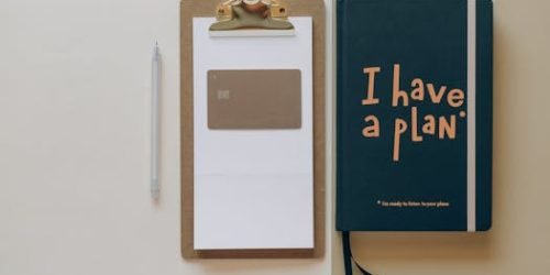pexels-photo-8062358-8062358 A minimalist office setup featuring a planner, clipboard, card, and pen, perfect for planning and organization.